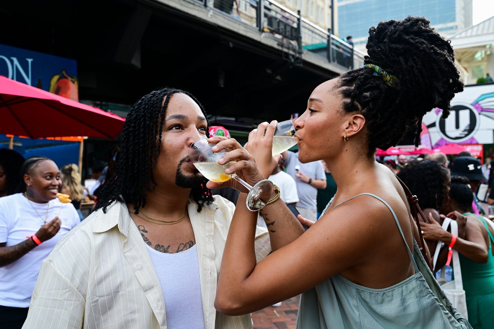 Guests enjoying the afternoon under the umbrellas — PeachFest 2026