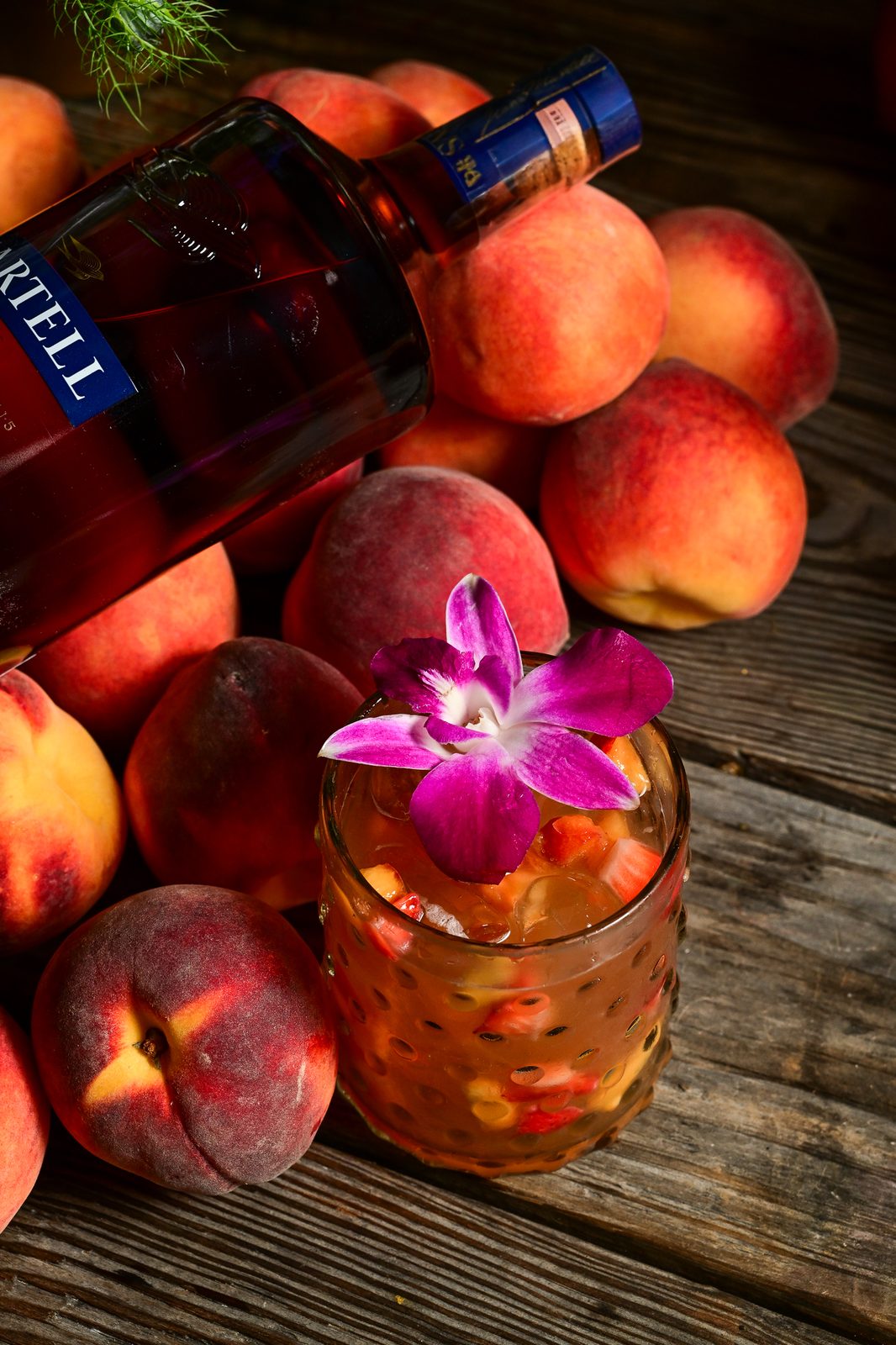 Martell cognac peach serve with an orchid garnish — PeachFest 2026